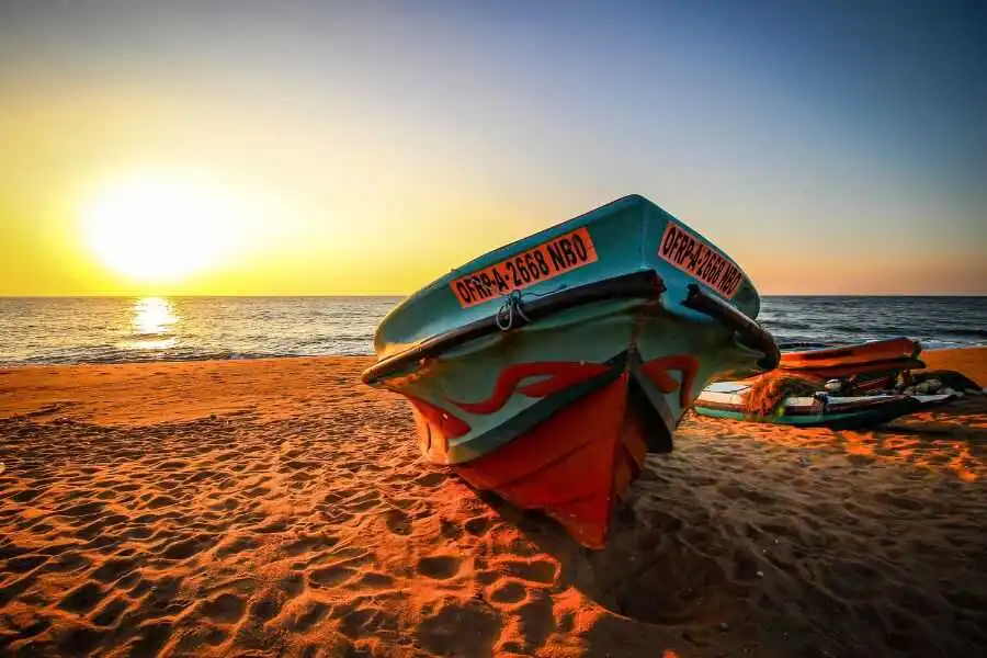 a boat on the beach with sunset negombo in sri lanka experiential journey