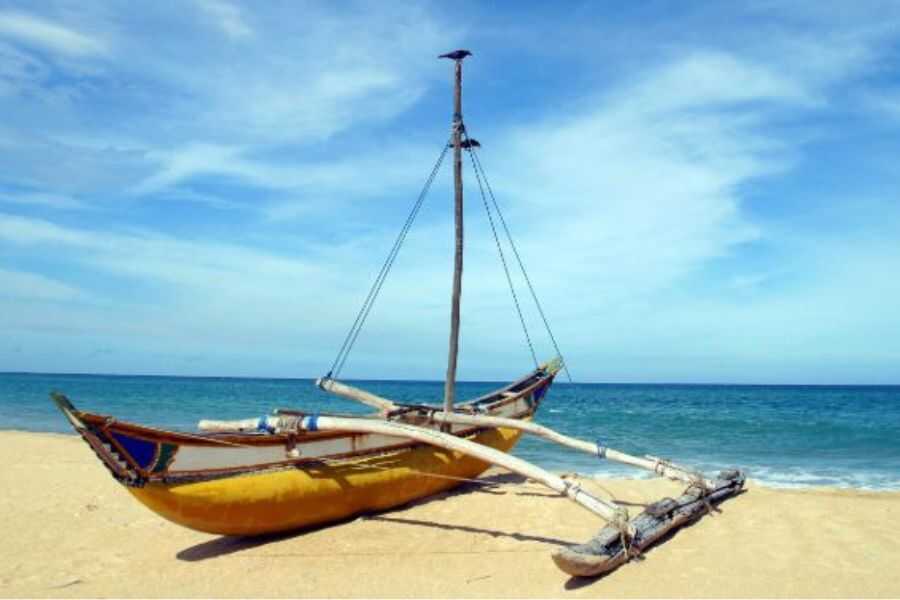 a boat on a beach with a cloudy sky experiential journey