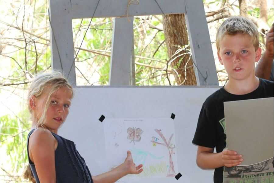 two boys with their paintings at our campsites in sri lanka experiential journey