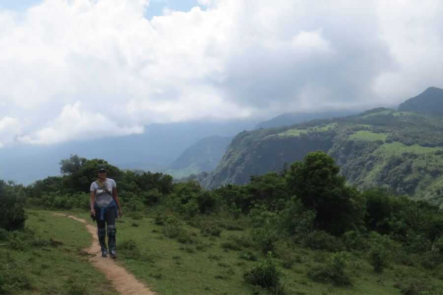 a girl is freely walking at knuckles sri lanka experiential joureny