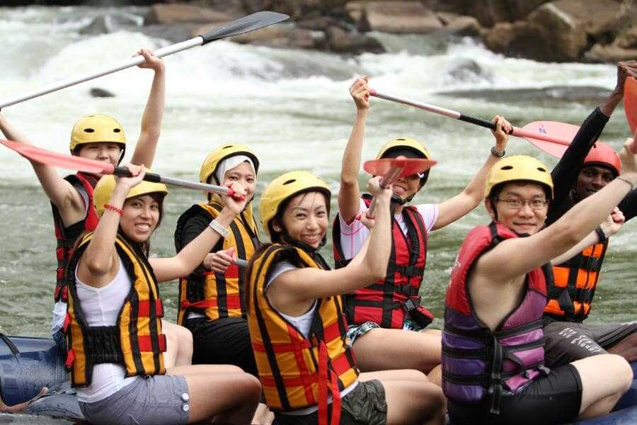 a group of peple enjoying water rafting at kithulgala sri lanka experiential journey